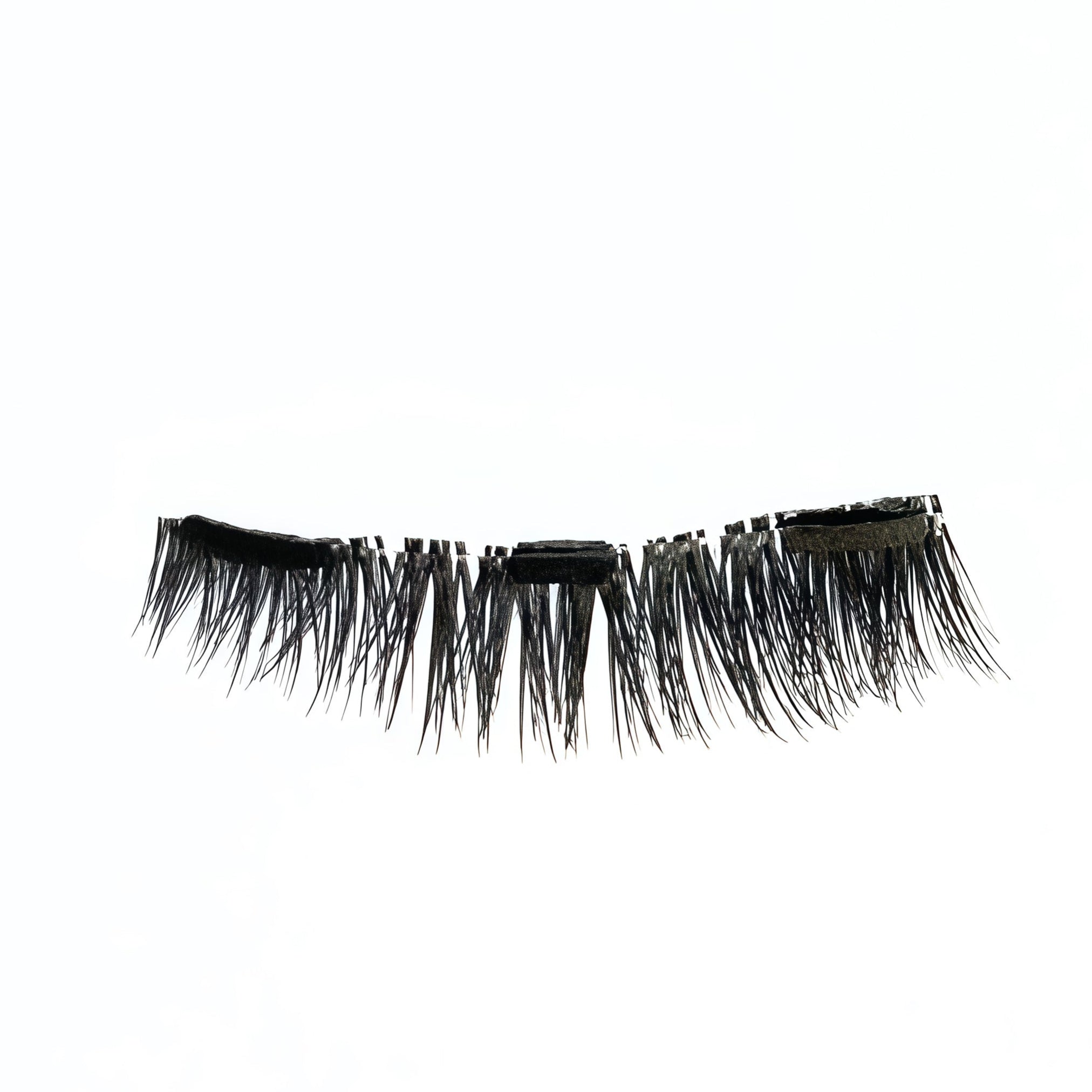 Close-up of a short, natural black cat-eye false eyelash on white background.