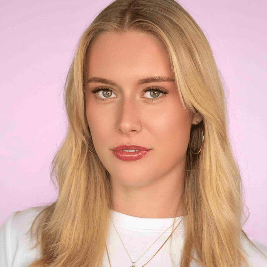 Close-up of a woman with short, wispy false eyelashes and soft natural eye makeup.