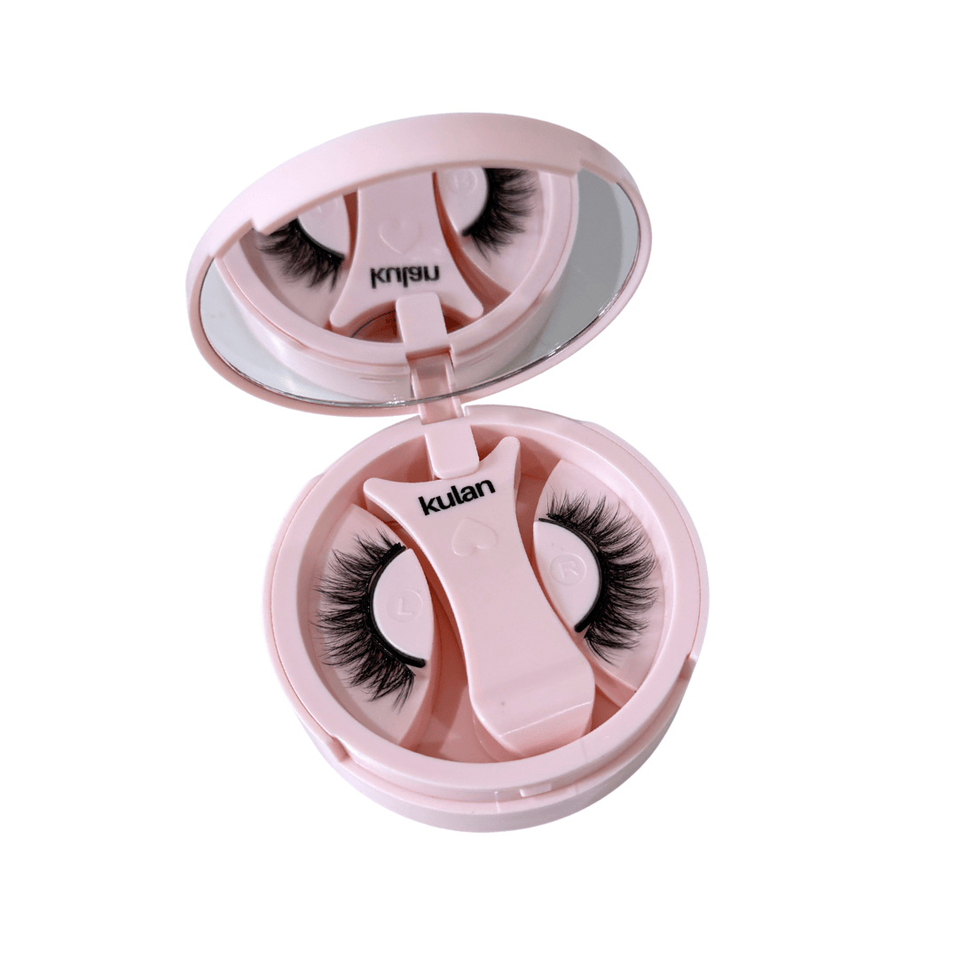 Pink case with false eyelashes and applicator on a white background